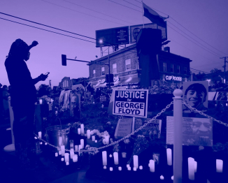 A person raises his fist at a memorial during a Celebration of Life festival in honor of George Floyd, who was killed by Minneapolis police one year ago, at George Floyd Square in south Minneapolis, Minnesota, U.S. May 25, 2021. REUTERS/Eric Miller - RC2DNN91GS94